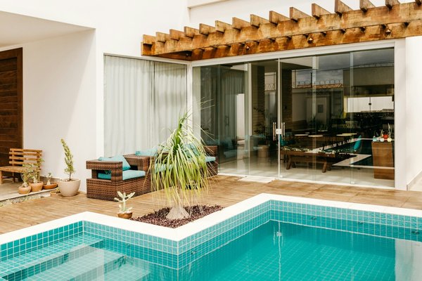 What are the benefits of using a dehumidifier in an indoor UK pool area?
